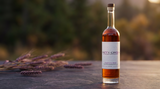 Purple Karma Barley Whiskey bottle with purple barley in warm Oregon light