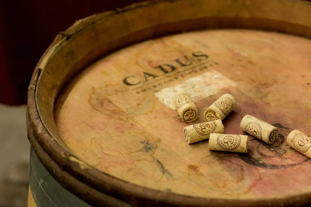 Patricia Green Cellars corks resting on an oak barrel