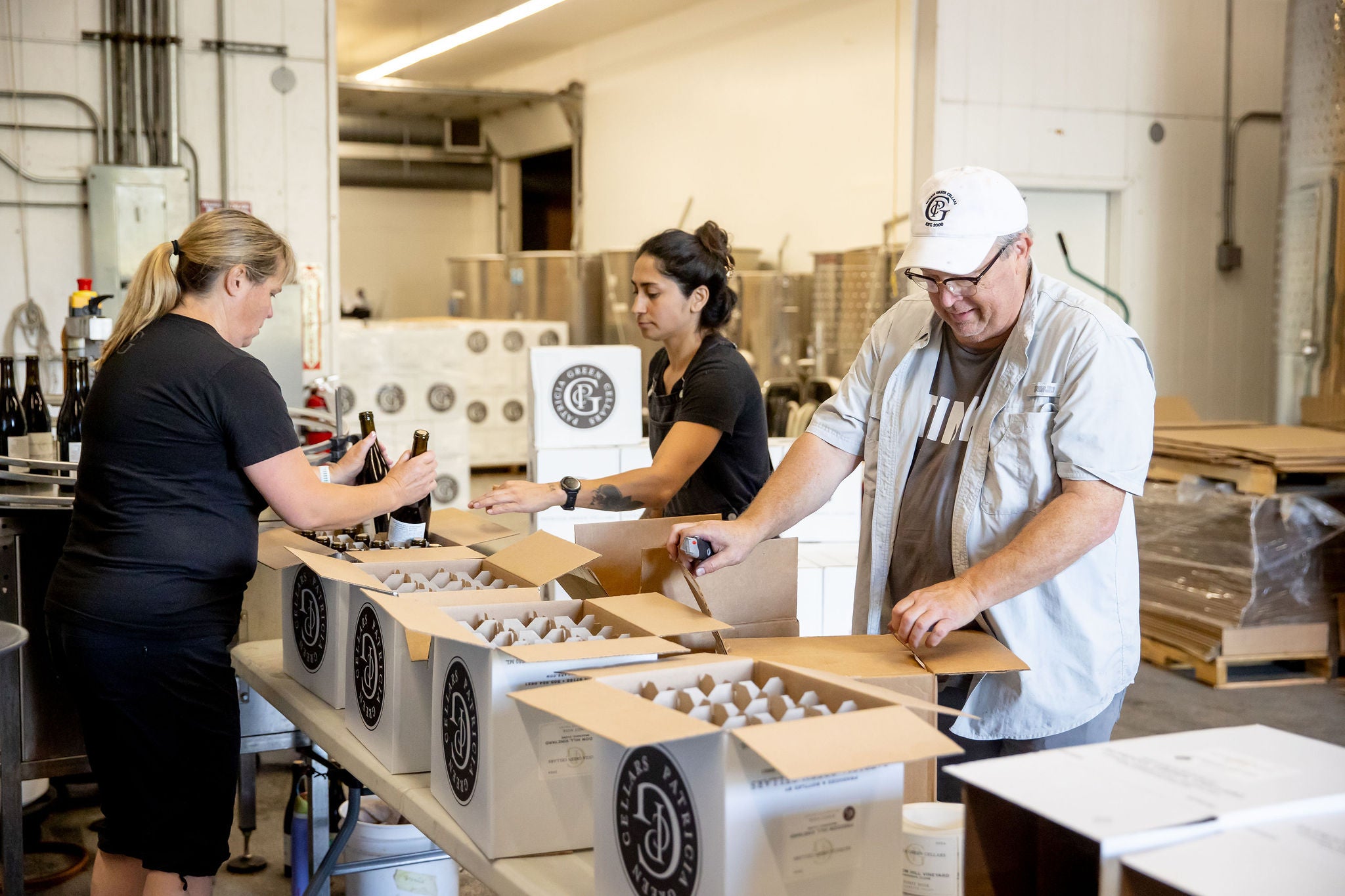 Patricia Green Cellars team packing bottles by hand